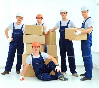 Local moving team handling packed boxes near an Epsom property