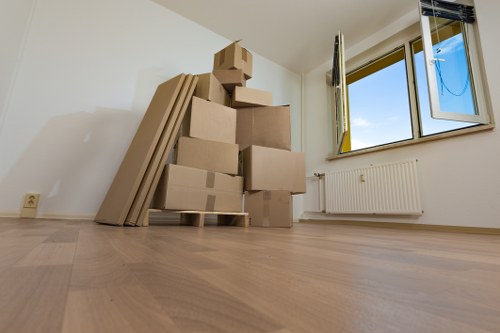 Packed boxes and furniture ready for loading into a removal van in Epsom