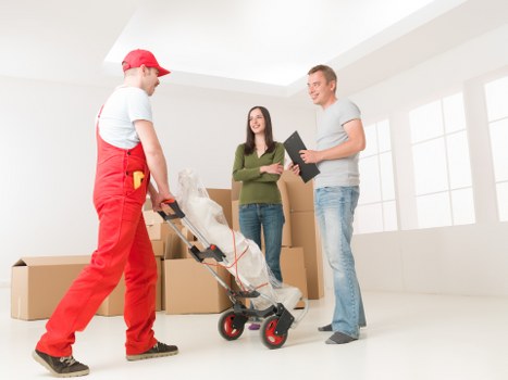Professional movers loading items for a house move